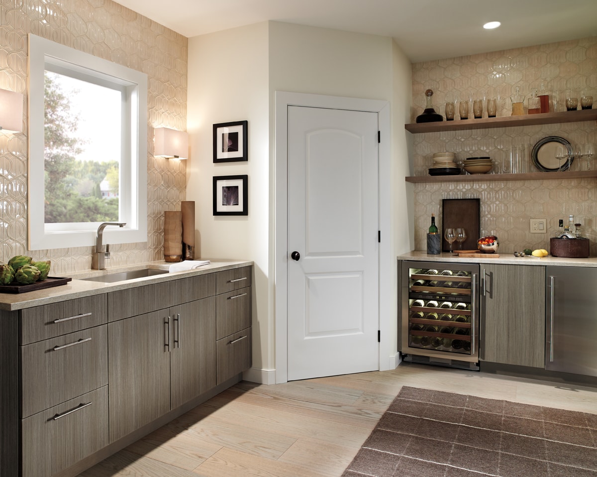 Large bar area with sink, wine fridge and cabinetry.