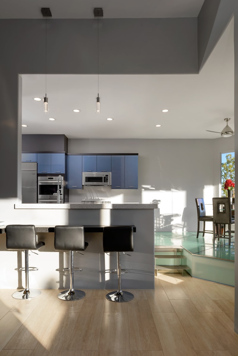 Contemporary Kitchen with bar seating leading into the living room.